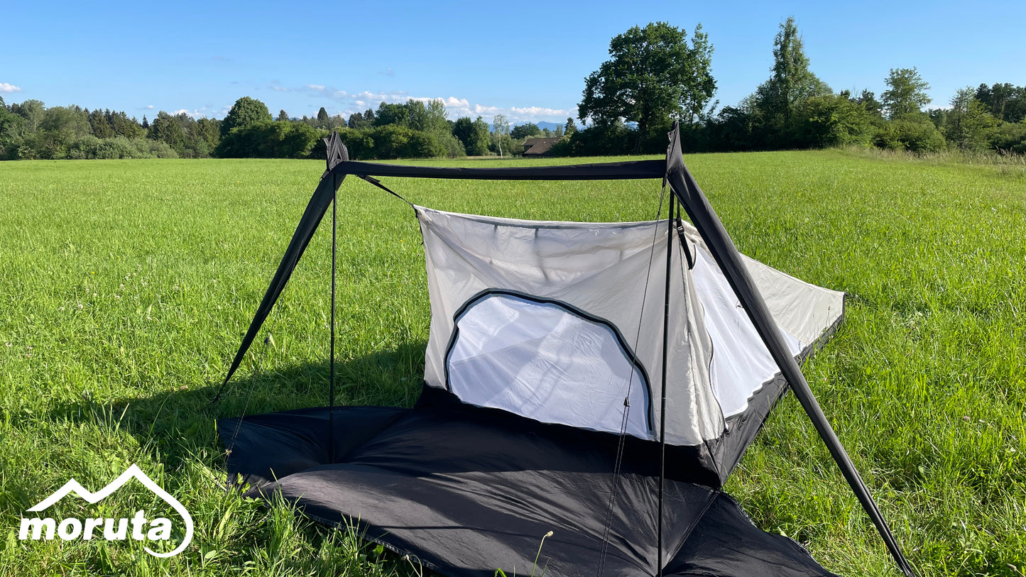 Moruta tent pitched in a picturesque mountain landscape, perfect for adventurous hikers and bikepackers seeking durable and reliable shelter.
